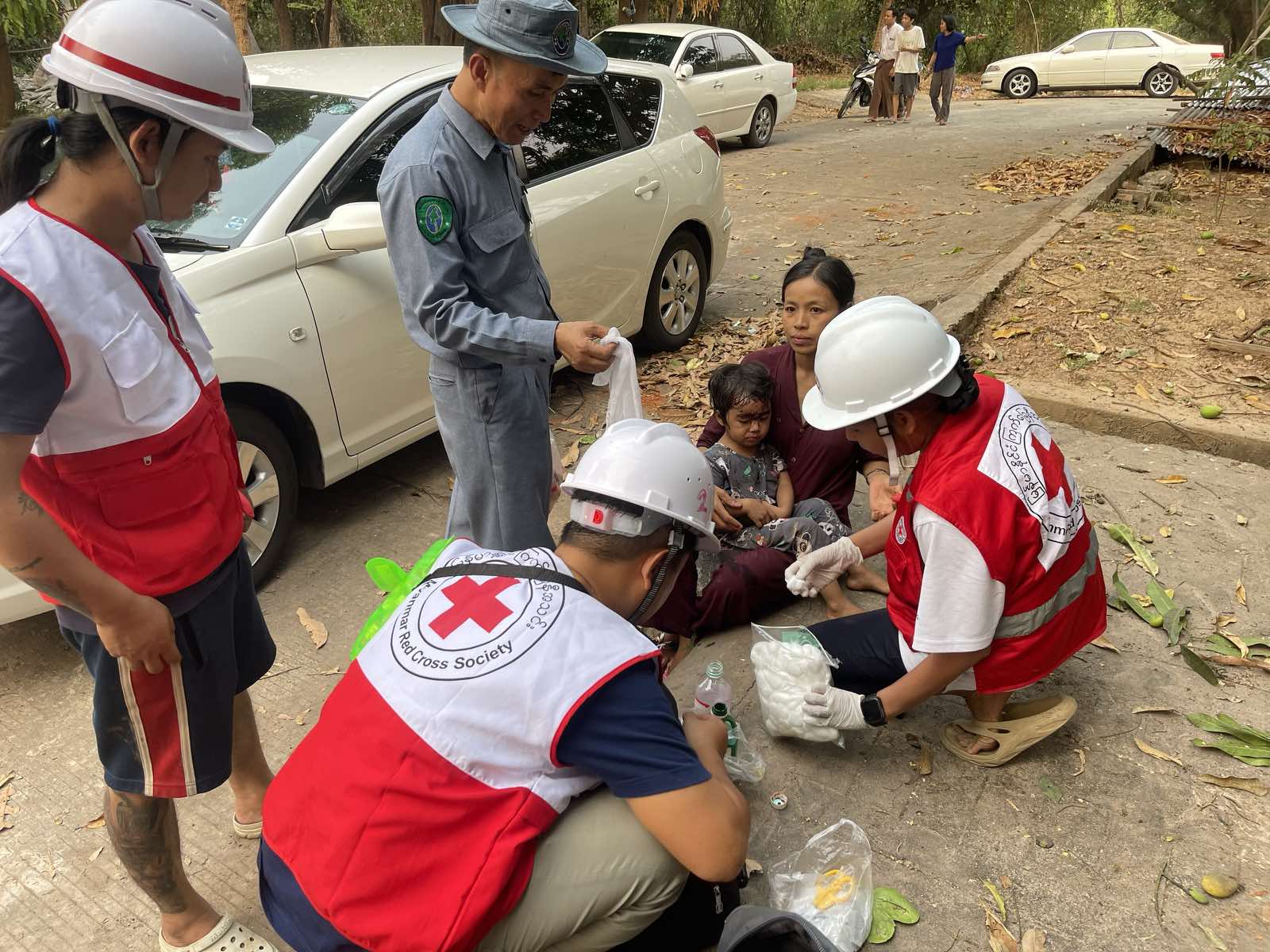 May Tha Gyan and other Myanmar Red Cross volunteers provide first aid to injured people after the March 28 quake.