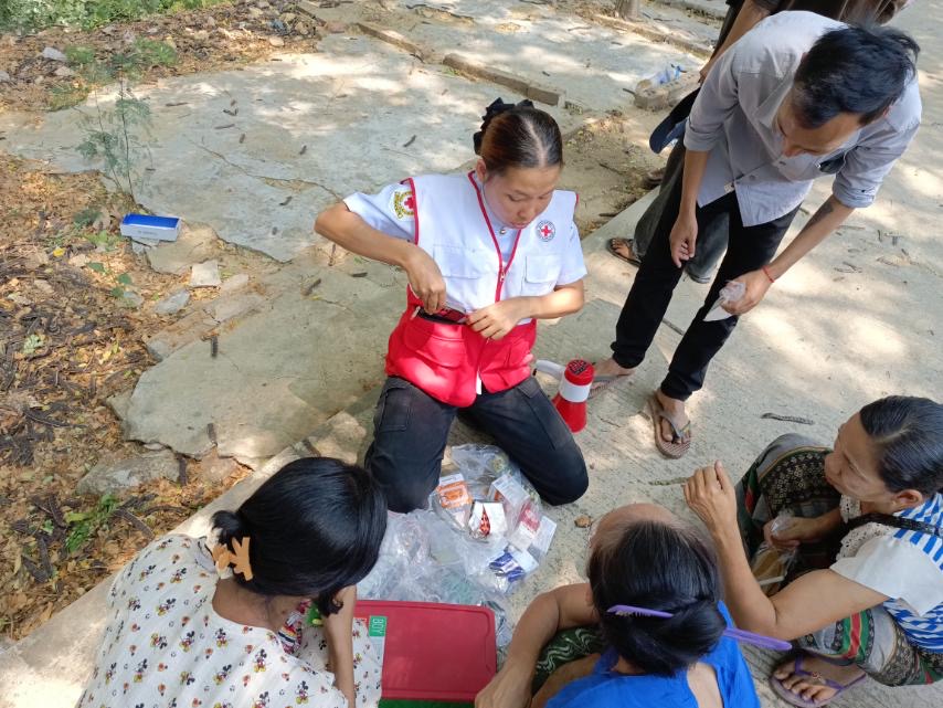 Myanmar Red Cross volunteer May Tha Gyan provides first-aid to people in the street following the March 28 earthquake in Myanmar.