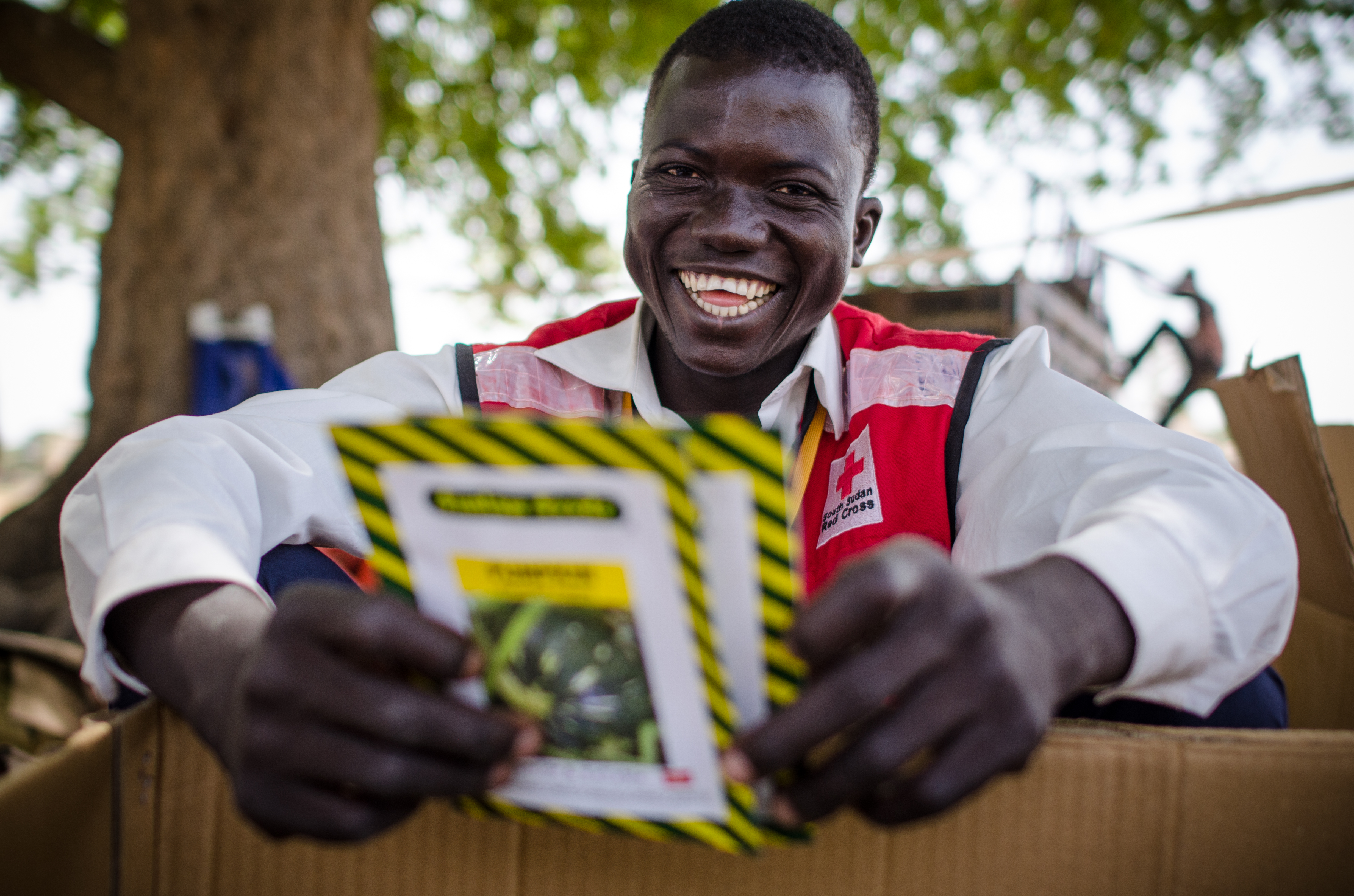 A South Sudan Red Cross volunteer shows seeds given out to women farmers in rural South Sudan to improve agriculture and food production in the onset of the rainy season. 