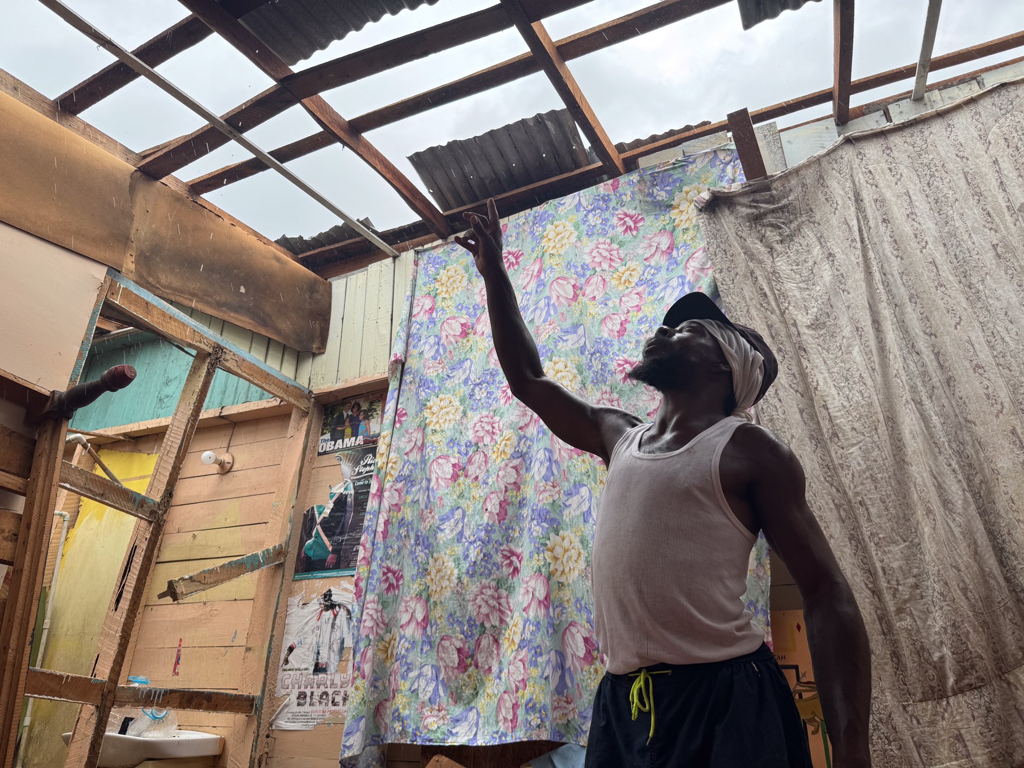  Hurricane survivor Dwayne Francis shows how winds from the Category 5 hurricane tore the roof completely of his home. 