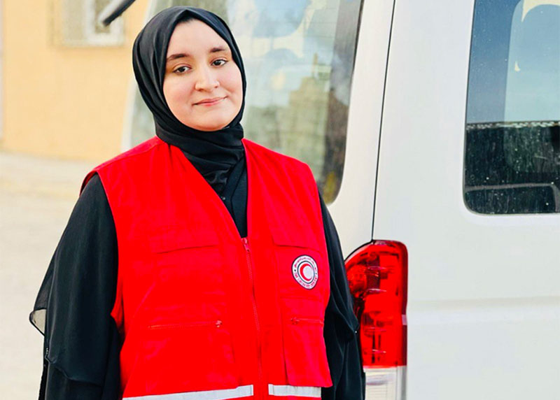 Libyan Red Crescent volunteer Hidayah Ahmed Saki proudly wearing her volunteer vest. 