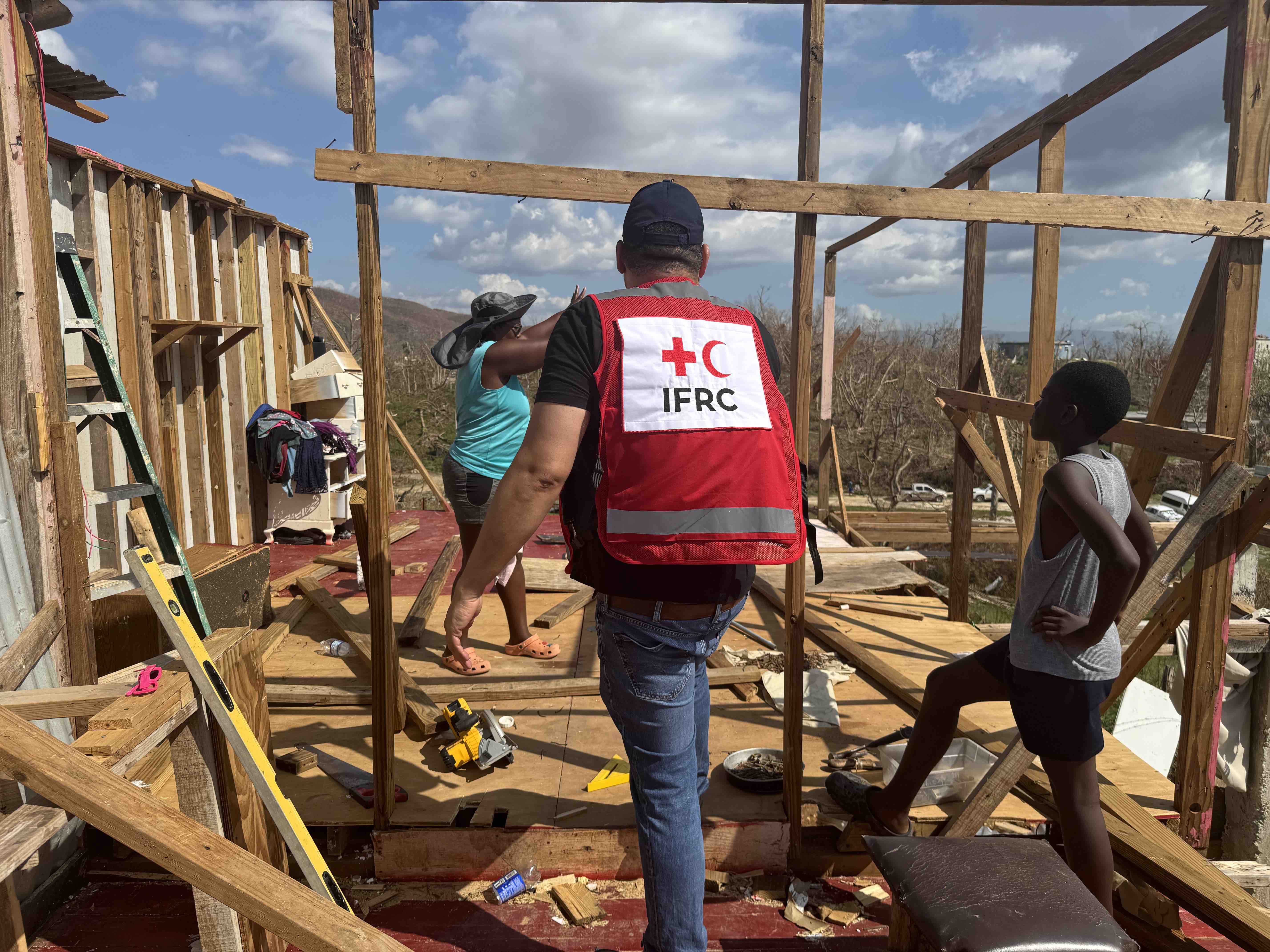 Hurricane survivor Marlene shows an IFRC staff member the near complete destruction of her home in Brompton, St. Elizabeth Parish in Western Jamaica. During the hurricane she sheltered with her three daughters in their concrete bathroom, the only room in their house still standing. Currently, the family are sleeping on the floor, on top of the clothes they managed to salvage.