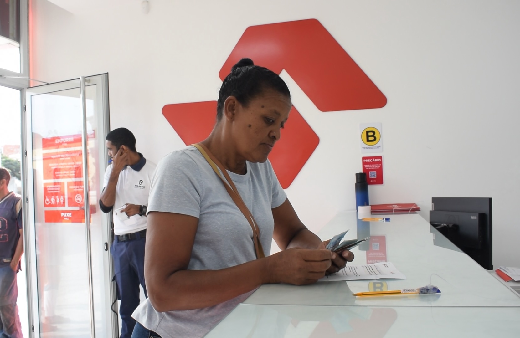 Vera Lucia is at the bank collecting cash provided by the Cape Verde Red Cross, which she’ll use to restart her vending business.