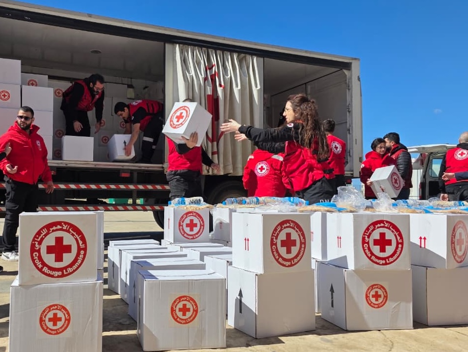 Lebanese Red Cross volunteers and staff prepare for a distribution of food and other essential living supplies.