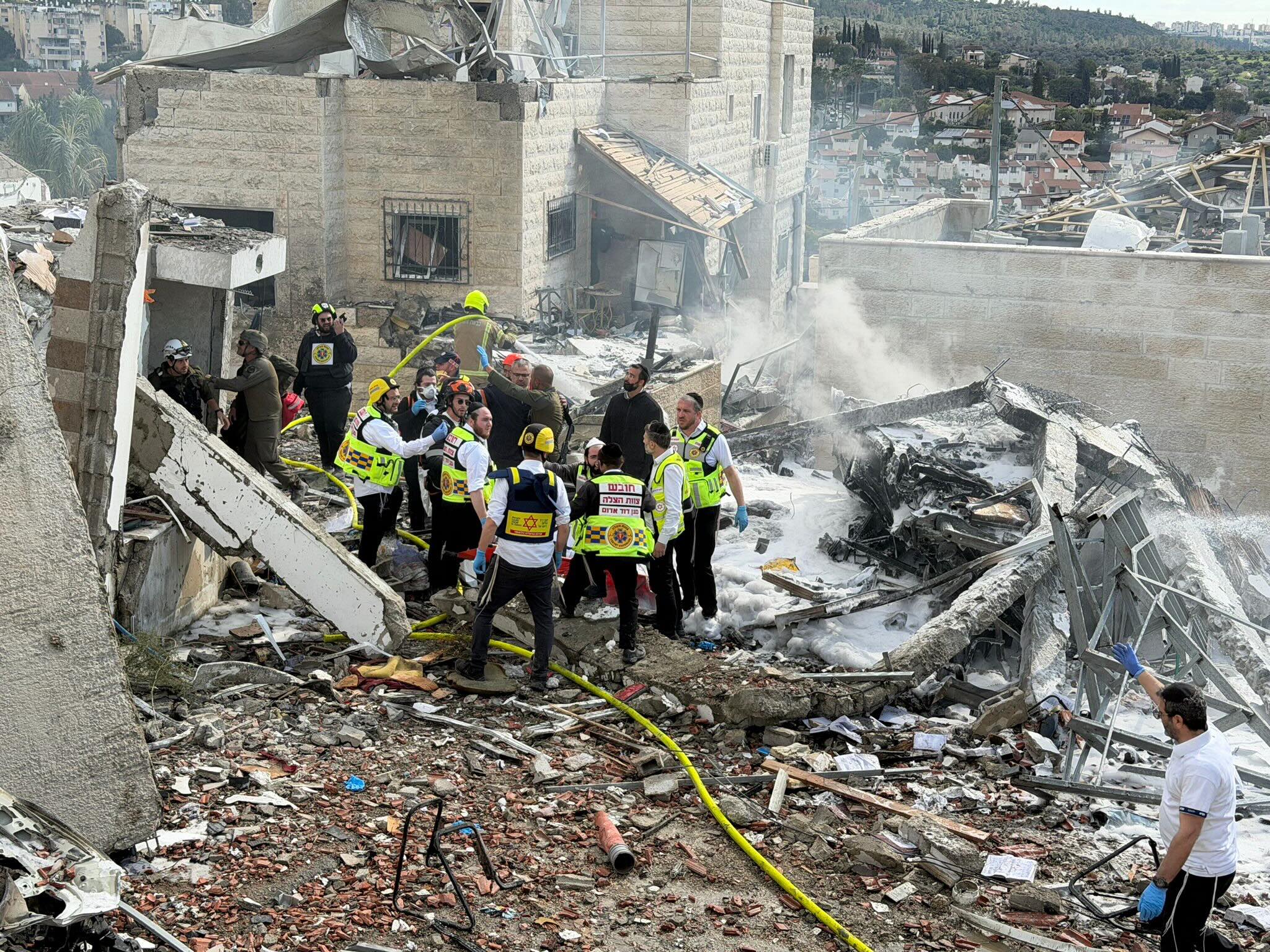 Emergency responders from Magen David Adom search for survivors and provide emergency services following an attack during the recent escalation in hostilities.