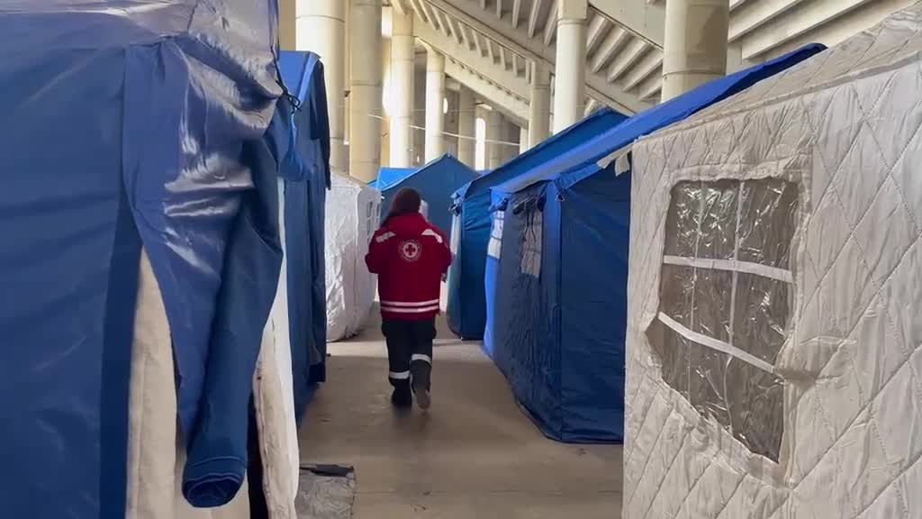 Nancy, a Lebanese Red Cross volunteer, delivers supplies to people living in shelters within the Camille Chamoun Sports City Stadium in Beirut.