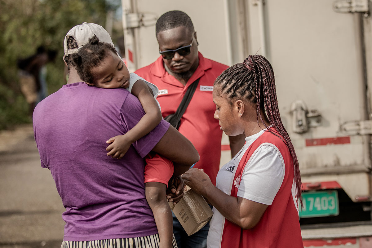 Jamaica Red Cross volunteers distribute shelter kits, food, water, blankets, and tarpaulins to families in Forest and Golden Grove communities in Jamaica in November 2025, providing essential emergency supplies in the aftermath of Hurricane Melissa.