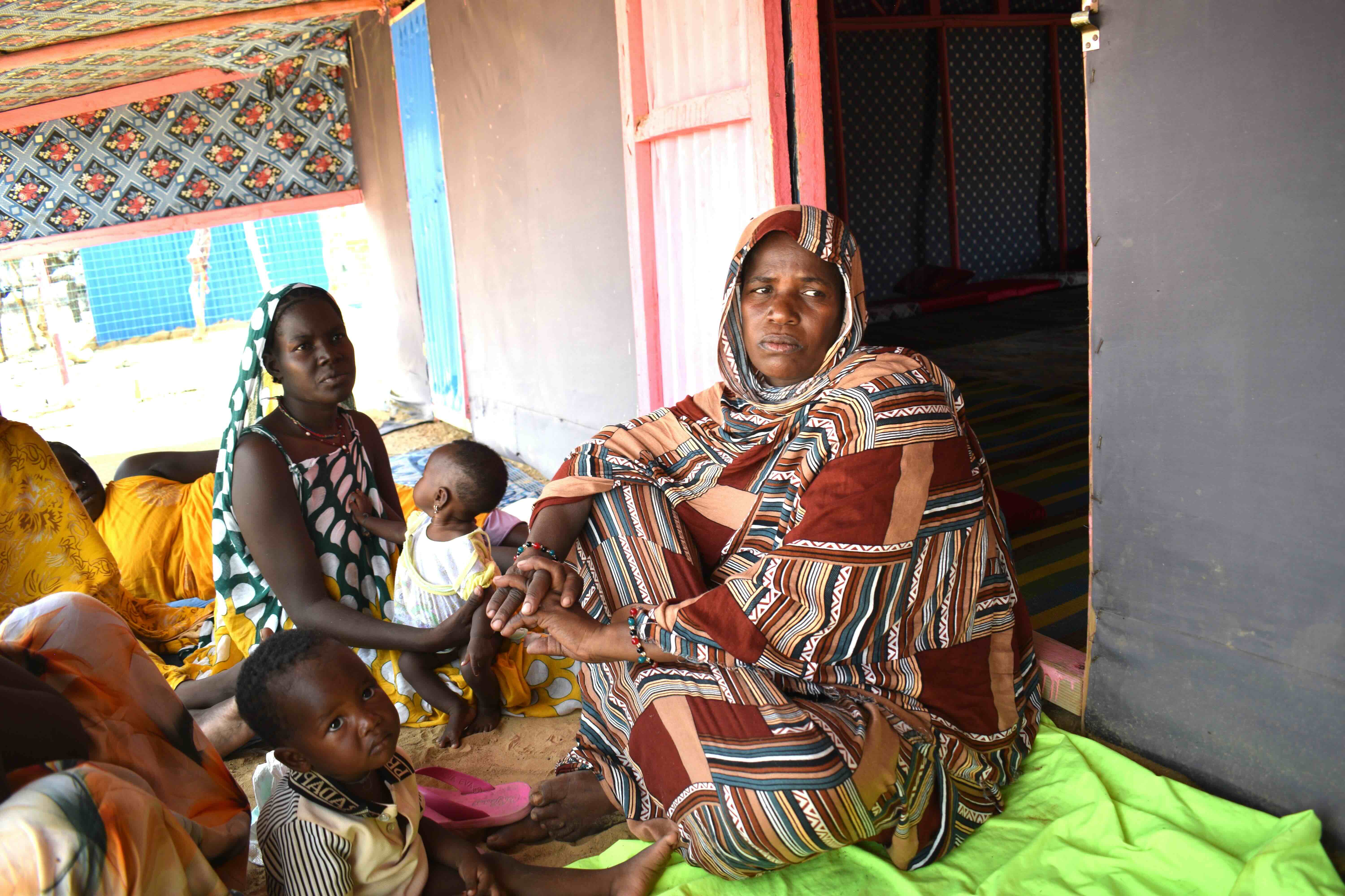 After a journey of several days from Mali to Mauritania under extreme heat, Bintou Mint Hamdi and family members gather at the rest area at the Mauritanian Red Crescent humanitarian service point in the Hodh El Chargui region in eastern Mauritania.