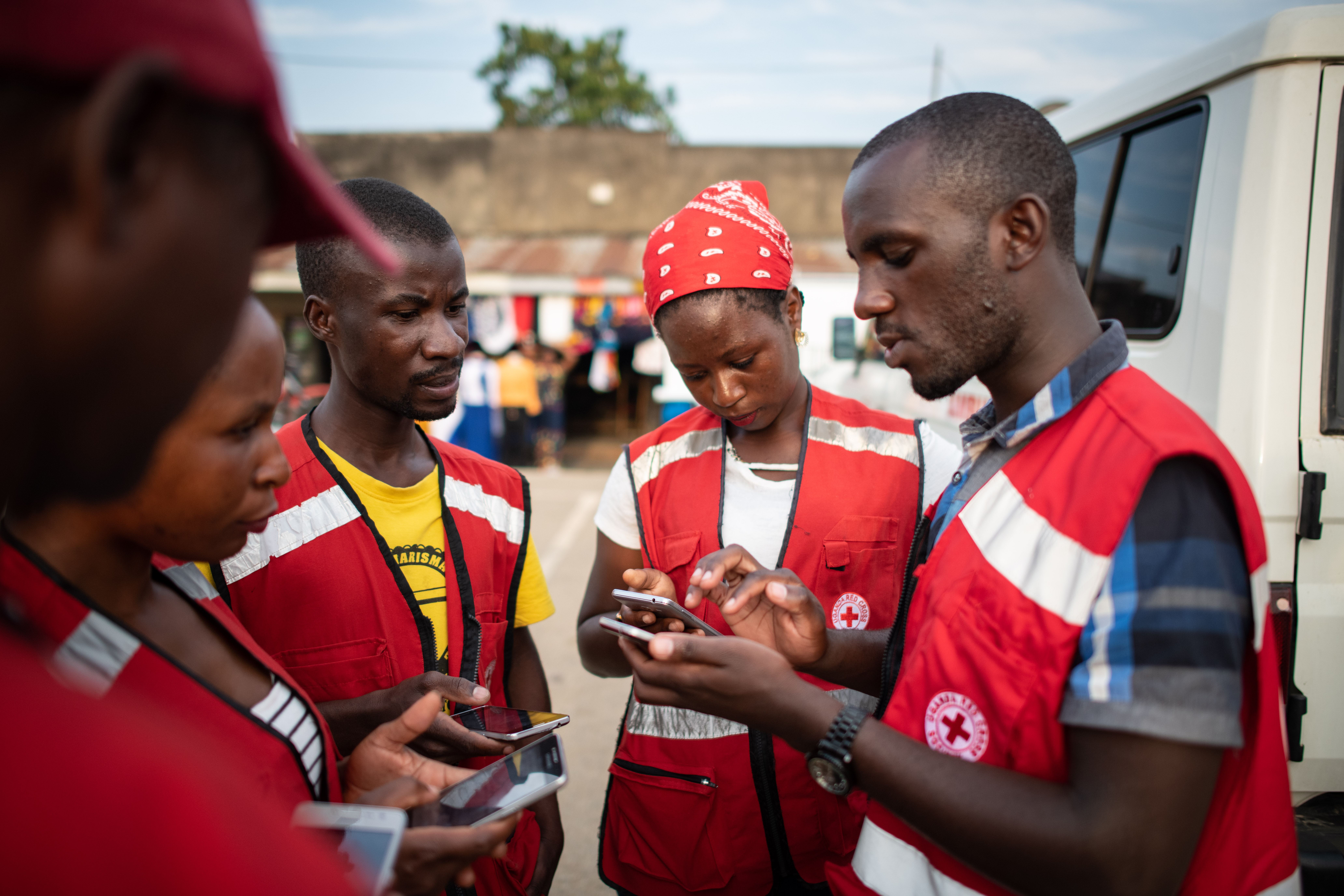Uganda Red Cross volunteers fan out to people in a business centre near the border of DRC using Kobo Collect before a mobile cinema takes place. The cinema provides a unique and engaging way for commu