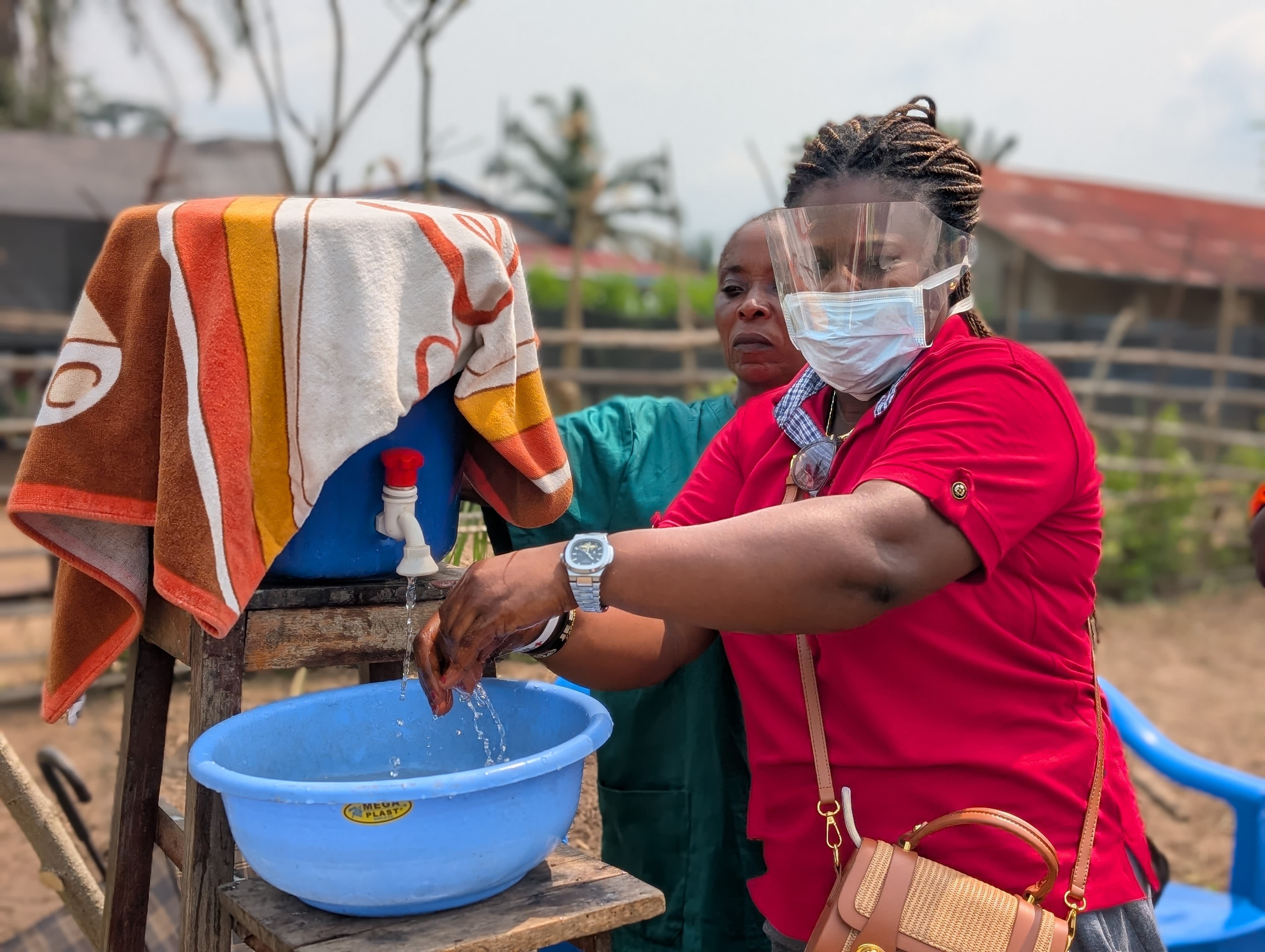 Handwashing remains a vital practice to curb the spread of the virus. Here, a Red Cross volunteer demonstrates proper handwashing to the community.
