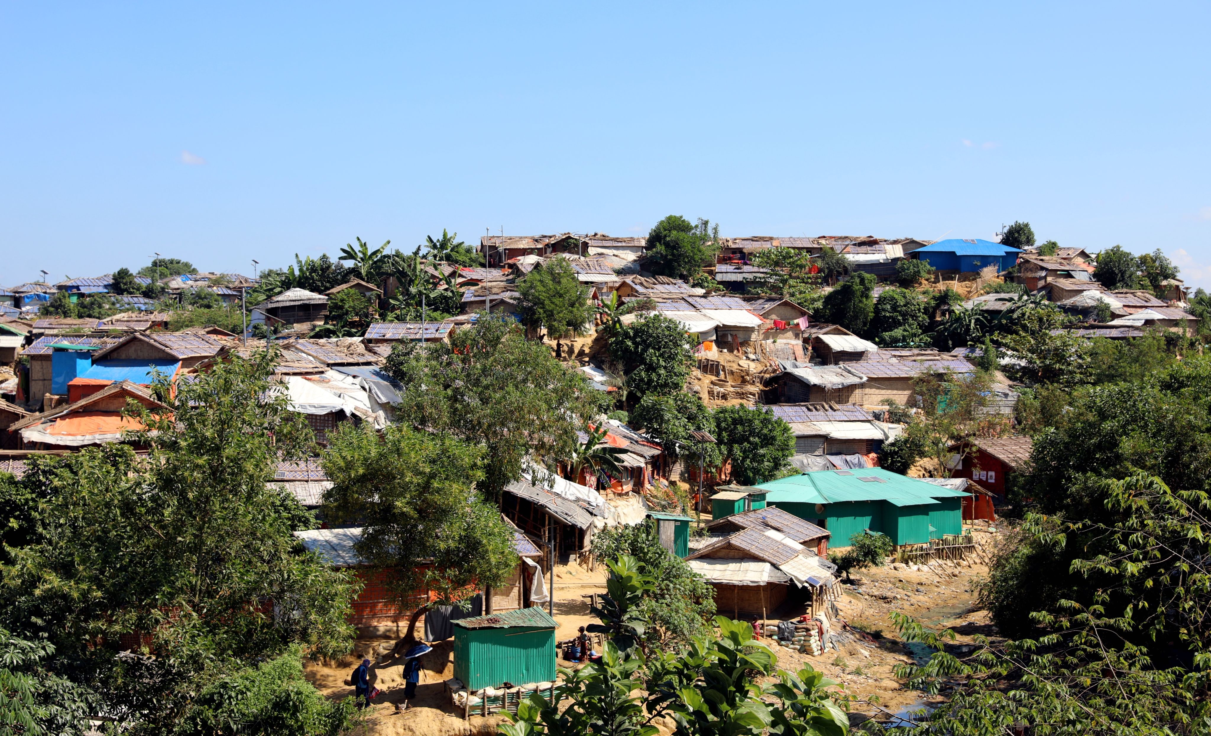 A hill crowded with small huts offers a glimpse into the challenges of living in the densely populated camps of Cox's Bazar.
