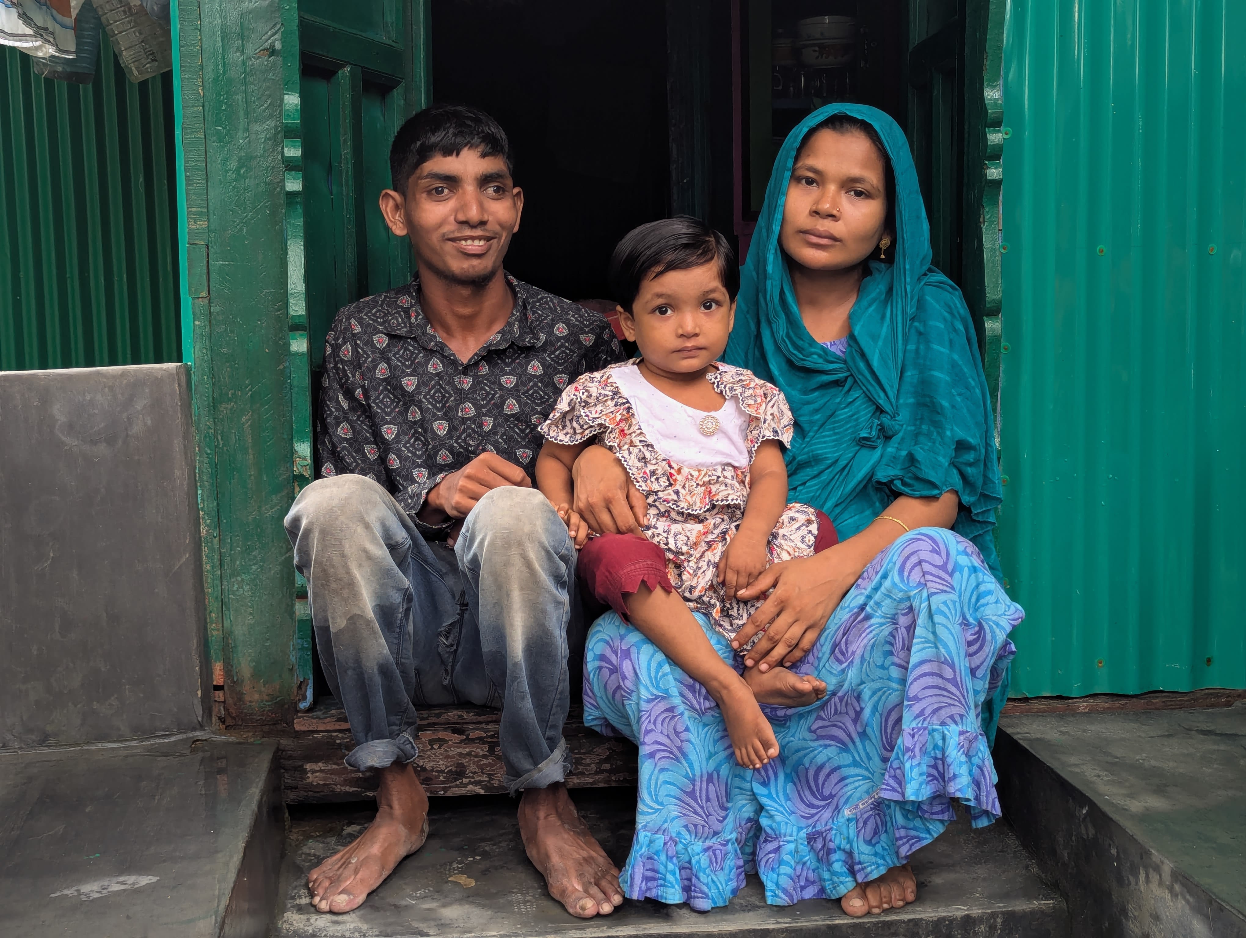 Ismail with his daughter and wife infront of his new home. Photo: Bangladesh Red Crescent