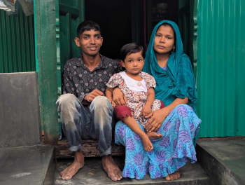 Ismail with his daughter and wife infront of his new home. Photo: Bangladesh Red Crescent
