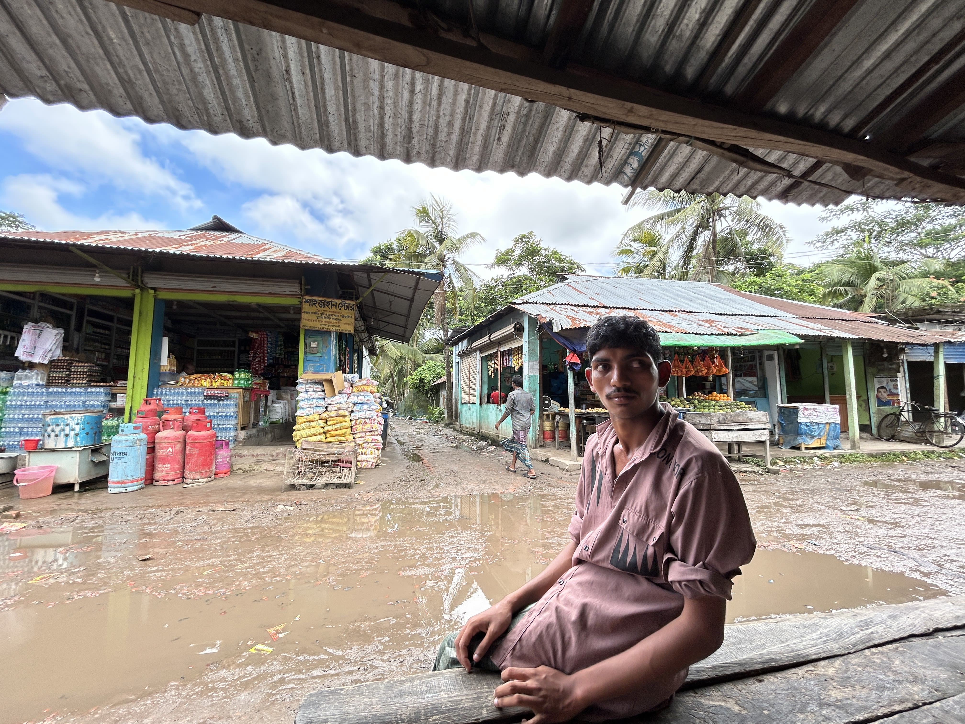 Ismail sits under the awning at a local market near his home. Photo: IFRC