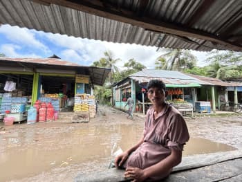Ismail sits under the awning at a local market near his home. Photo: IFRC
