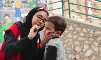 A volunteer for the Egyptian Red Crescent gives her time to provide some joy and a sense of normalcy to people who fled conflict in Gaza.