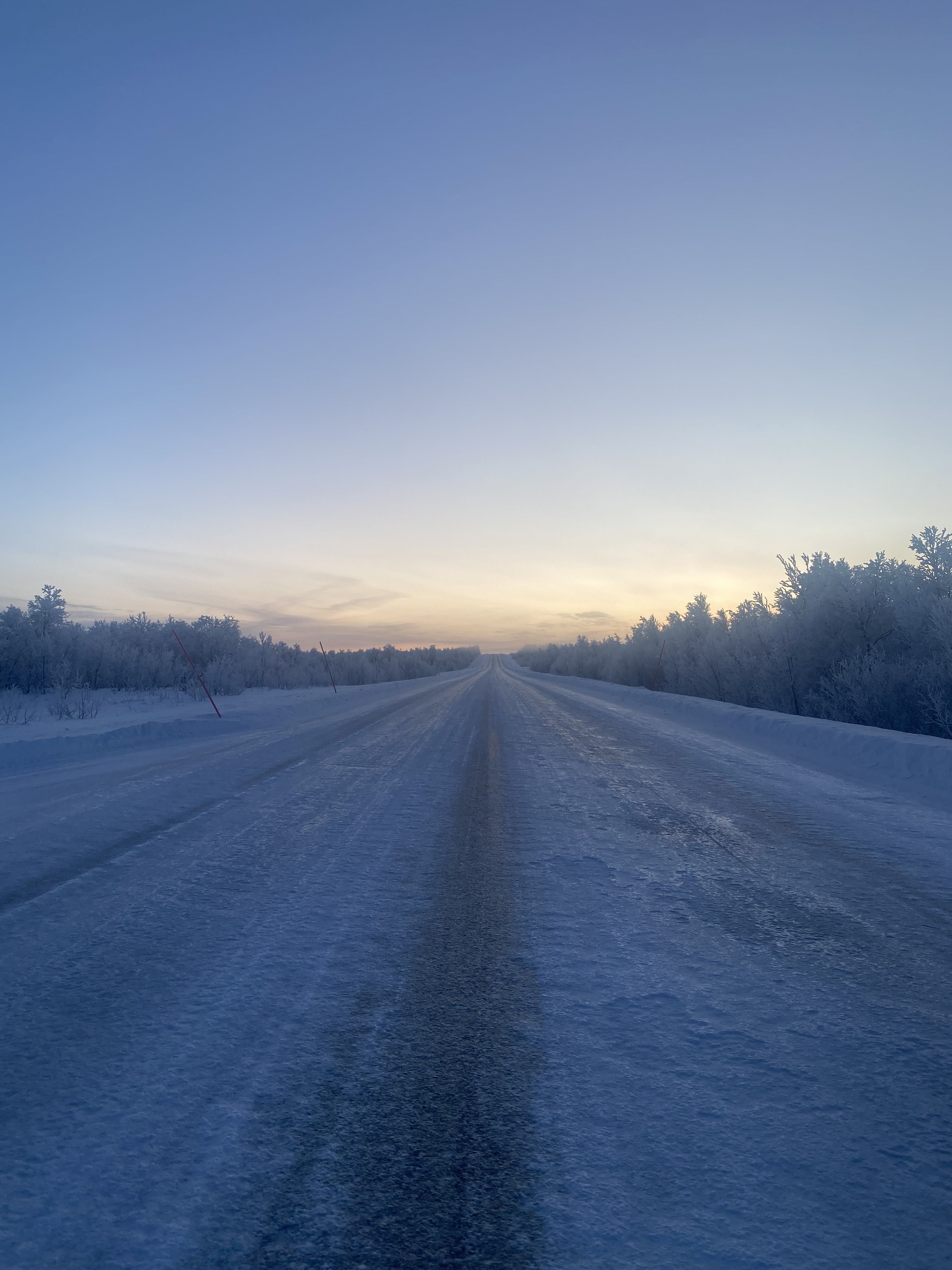 A snowy,  ice-covered road disappears into the distance. In the Arctic, where resources are limited, preparedness is everything. Photo: Gabriella Jurisic&nbsp;Ottesen/Norwegian Red Cross