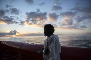 After being rescued at sea, a migrant from Ethiopia looks out over the sea in a moment of reflection. Photo: Alexia Webster