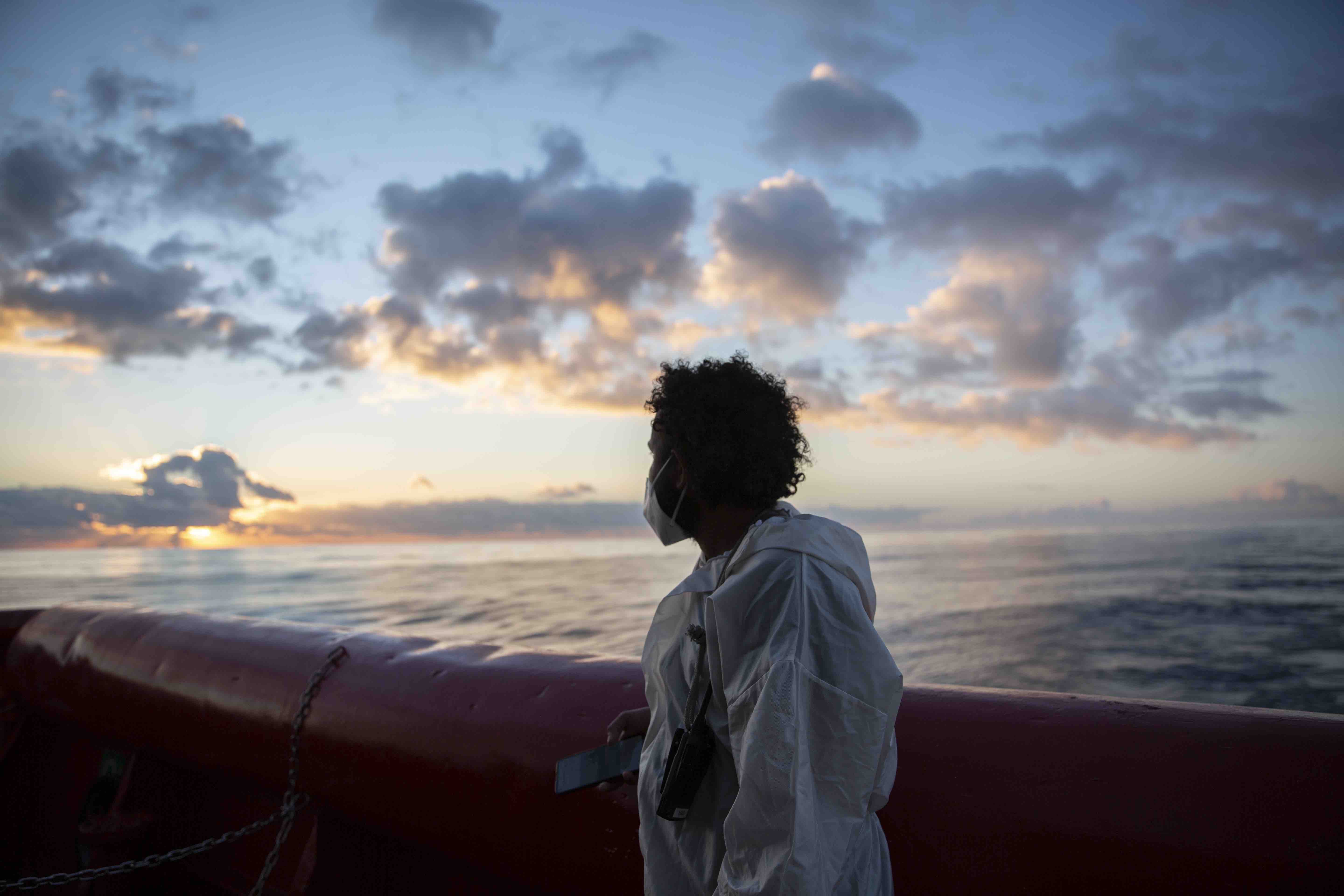After being rescued at sea, a migrant from Ethiopia looks out over the sea in a moment of reflection. Photo: Alexia Webster
