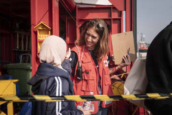 IFRC protection team leader Camille Coletta speaks with a woman rescued from a boat lost at sea and now safely on board the Ocean Viking.Camille Martin Juan /SOS MEDITERRANEE