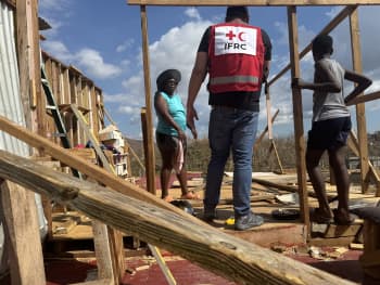 Marlene talks about her experience and talks about her immediate and future needs with an IFRC representative.