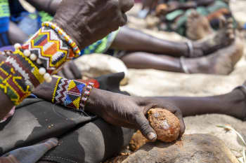 A caregiver prepares mkoma (doum palm fruit), a foraged food that sustains families in Lopur, Turkana, where drought has stripped livelihoods and deepened food insecurity.