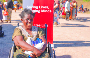Elia Sialanga receives her hygiene kit during a Zambia Red Cross distribution of household and hygiene goods in Sinazongwe District.