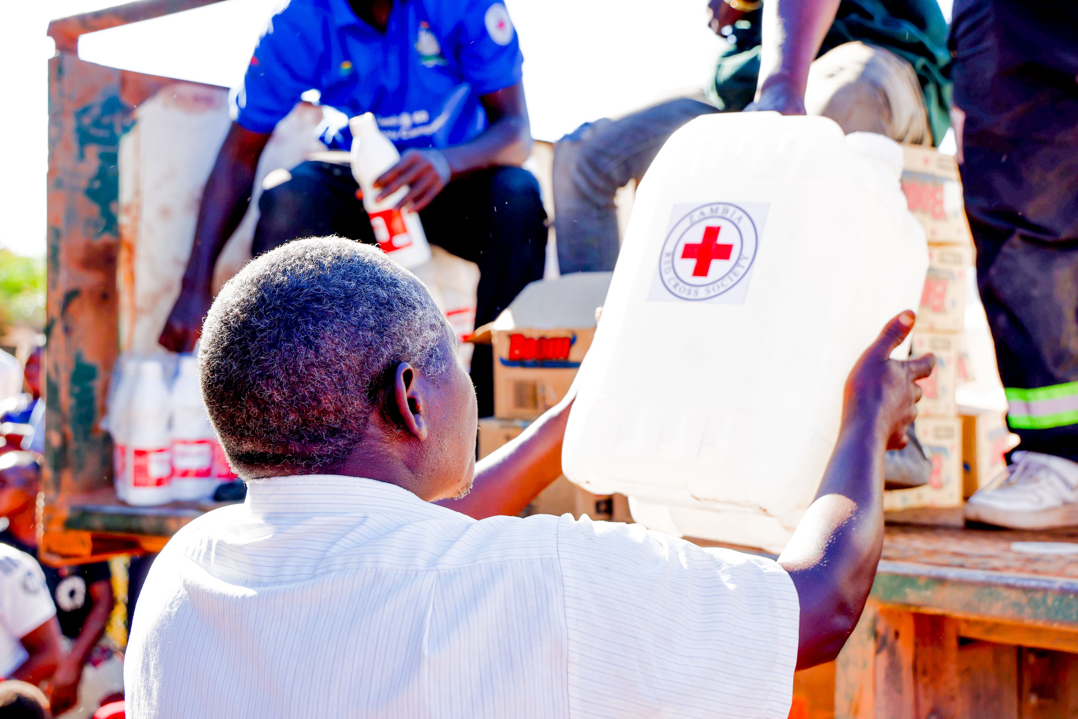 A man collects a water container and chlorine from a Red Cross distribution point in Sinazongwe District.