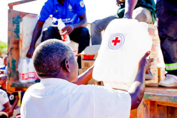 A man collects a water container and chlorine from a Red Cross distribution point in Sinazongwe District.