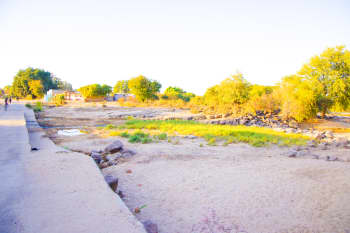 Where water once brought life, drought has left emptiness. The dried-up river in Sinazongwe cuts through homes and livelihoods.