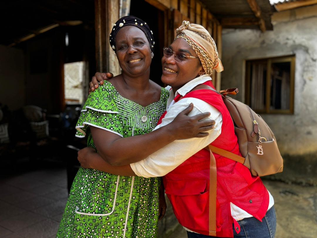 Ursula, a volunteer with the Gabonese Red Cross, comforts a woman affected by the violent winds in Gabon