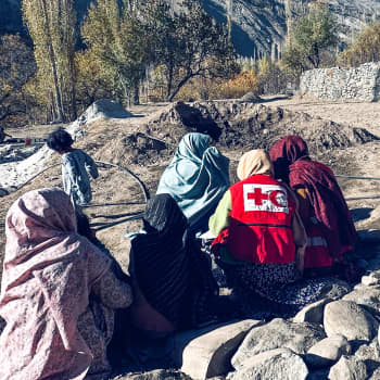 A representative from the IFRC speaks to a group of women to better understand the villagers' needs after the flood.