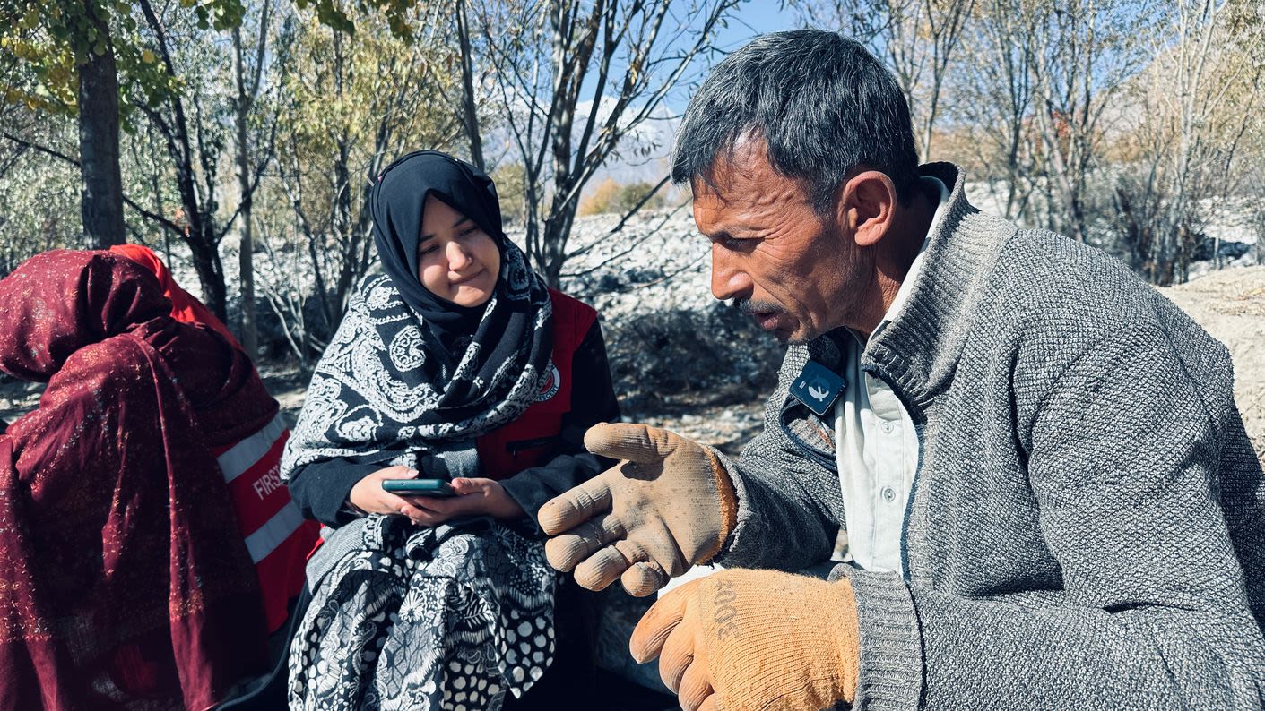 A man who lives in Hurchus village speaks with Aqueela Zehra, a volunteer with the Pakistan Red Crescent during a detailed assessment of the villagers' needs following the floods. 