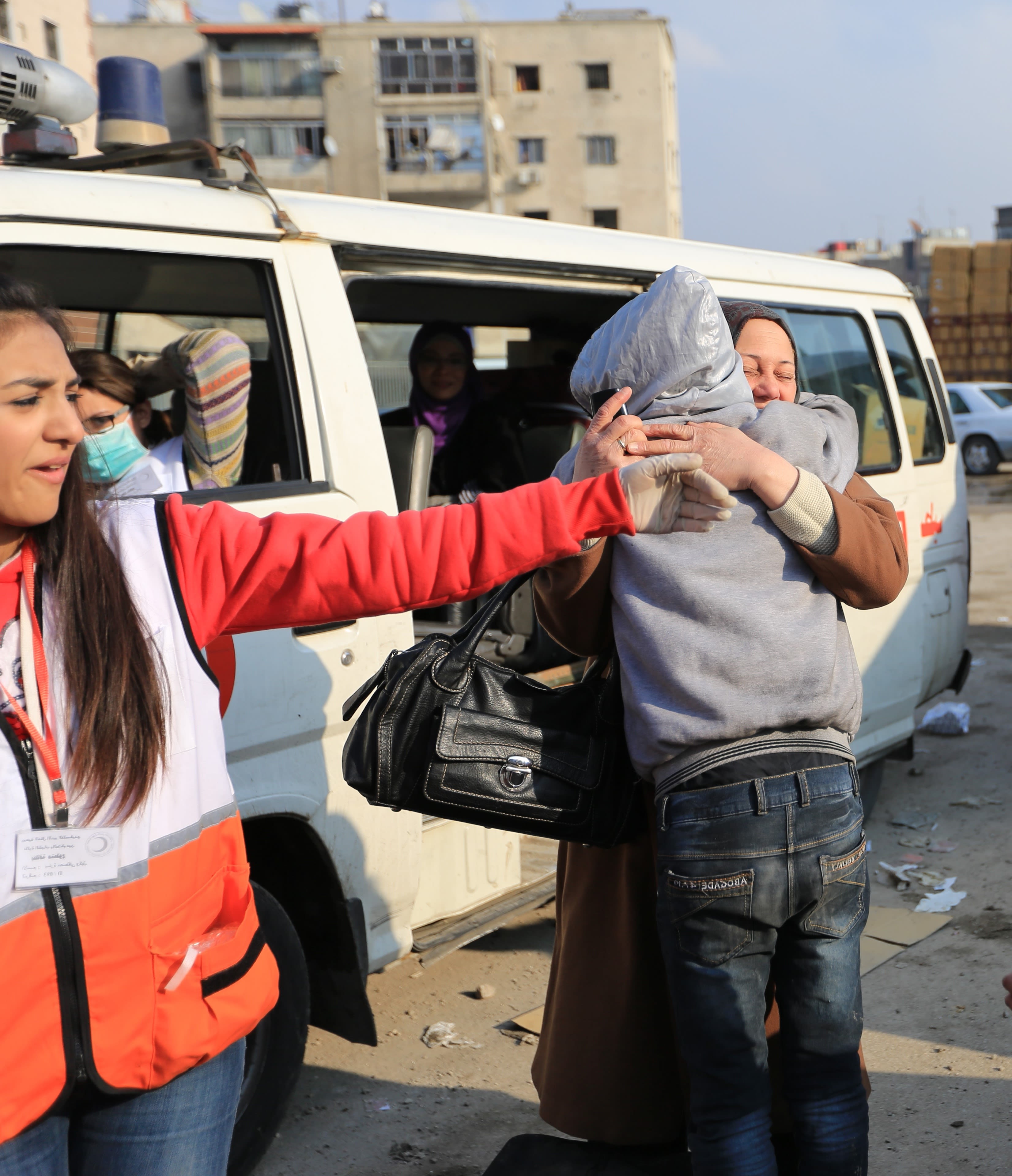 Members of a family, who were separated for a long time, are reunited after an evacuation organized jointly by the Syrian Arab Red Crescent from Damascus branch and the Palestinian Red Crescent, after the Palestinian Camp of Yarmouk in Damascus was under siege. Photo: IFRC