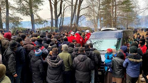 Belarus Red Cross volunteers distribute food, water, hygiene kits, blankets and clothing to groups of people trying to leave the country who set up makeshift camps on the border with Poland in early November 2021.
