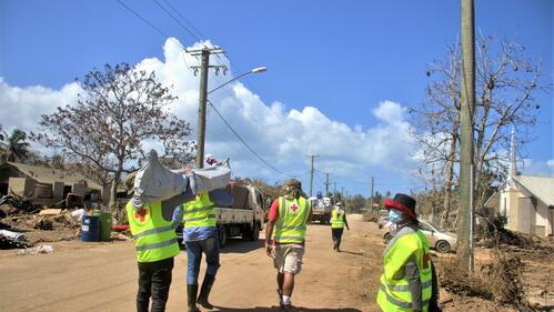 Tonga Red Cross Society volunteers carry shelter equipment to set up temporary housing for people affected by the Hunga Tonga Hunga Ha’api volcanic eruption and tsunami in January 2022.