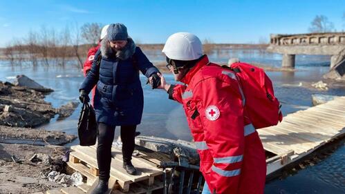 After a bridge to Demydiv, Ukraine was damaged in hostilities in April 2022, Ukrainian Red Cross emergency response team volunteers built a crossing over the river and helped evacuate more than 15,000 people.