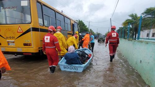 Cuban Red Cross volunteers transport an elderly lady via boat through flood waters caused by Hurricane Ian, which battered the region in late September 2022. Many National Societies in the region responded to help affected communities cope with the damage caused by the category 4 hurricane.