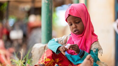A young girl sits and plays quietly in Qaloàto village, Somaliland, where people are experiencing the worst drought in decades. The Somali Red Crescent Society together with its partners are doing what they can to support people struggling because of the drought. Many people have lost parts of, or all their livestock and are living in a very difficult situation.