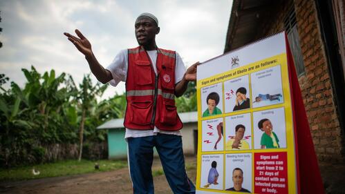 A Ugandan Red Cross volunteer speaks to communities about how to stay safe from the Ebola virus disease - responding to people's concerns and questions.