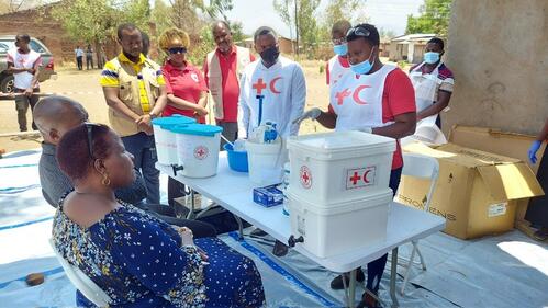 Malawi Red Cross volunteers educate members of their local community about cholera risks and how they can access treatment and care amid a country-wide outbreak in 2022