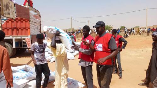 Sudanese Red Crescent Society volunteers distribute food to people in Khartoum who have been affected by the ongoing conflict in the country in late May 2023.