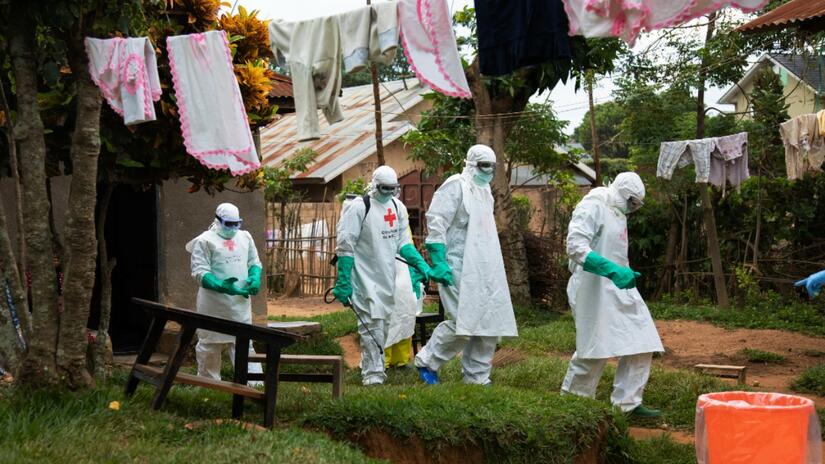 An IFRC safe and dignified burial team respond to an alert from family members who have lost a loved one suspected of Ebola.