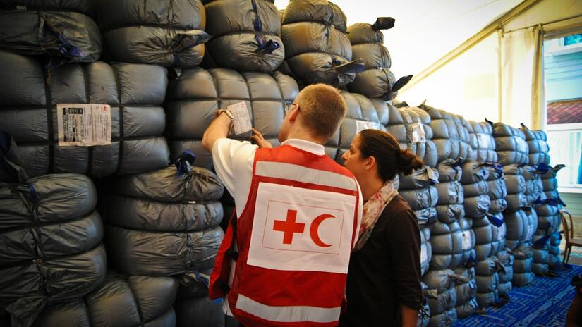 IFRC staff inspect humanitarian supplies at a logistics warehouse in Cox's Bazar, Bangladesh