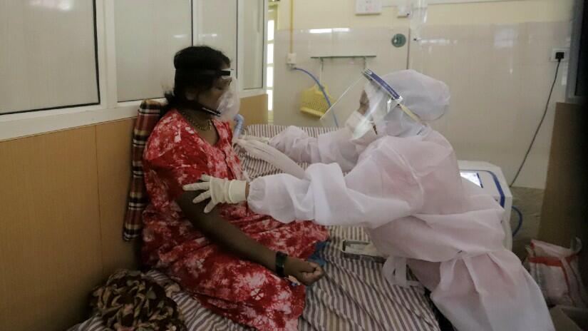 A health worker attends to a COVID-19 patient who requires breathing support in Bel Air Hospital, Panchgani, Maharashtra.