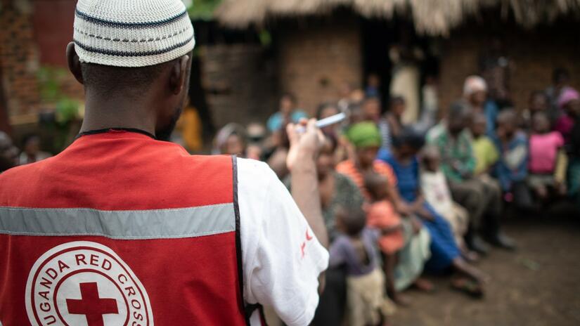 A volunteer from the Ugandan Red Cross speaks to communities about how to recognise early signs of disease outbreaks to help people stay safe from Ebola and other health threats