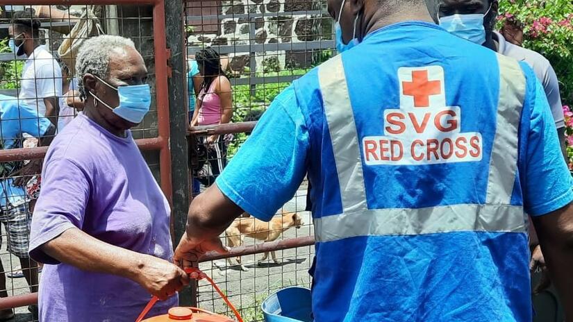 St. Vincent and the Grenadines Red Cross volunteers hand out cleaning kits to persons affected by the La Soufrière volcano eruption, as they continue the clean-up process to transition back home, six months later.