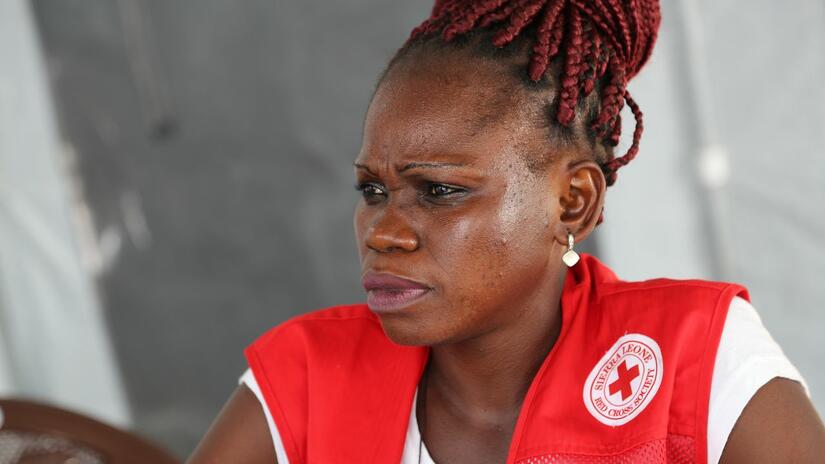 Sierra Leone Red Cross teams have responded to other major disasters in the past, including the August 2017 mudslides that killed over 1000 people. Here a Red Cross volunteer Isha Wilson-Clarke conducts a one-on-one session with a man who survived the mudslide at Regent.