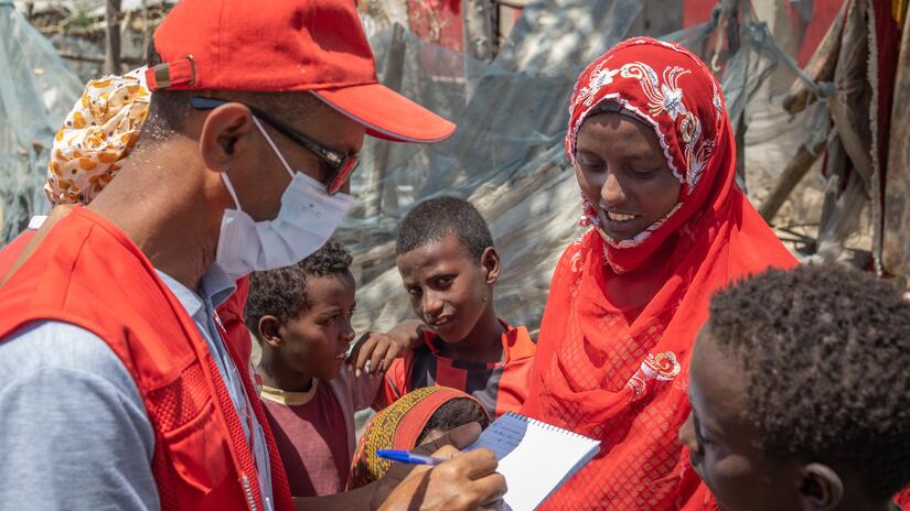 Ethiopian Red Cross volunteer collects information from a family