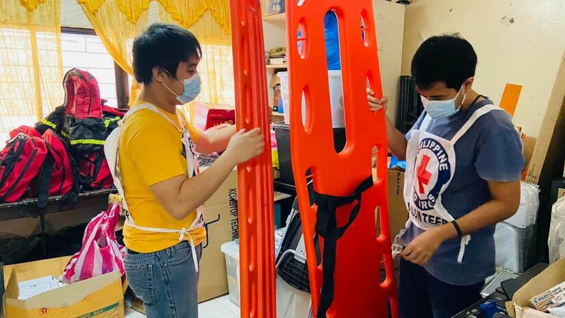 Volunteers of Philippine Red Cross prepare the safety and rescue equipment in preparation for Typhoon Odette.